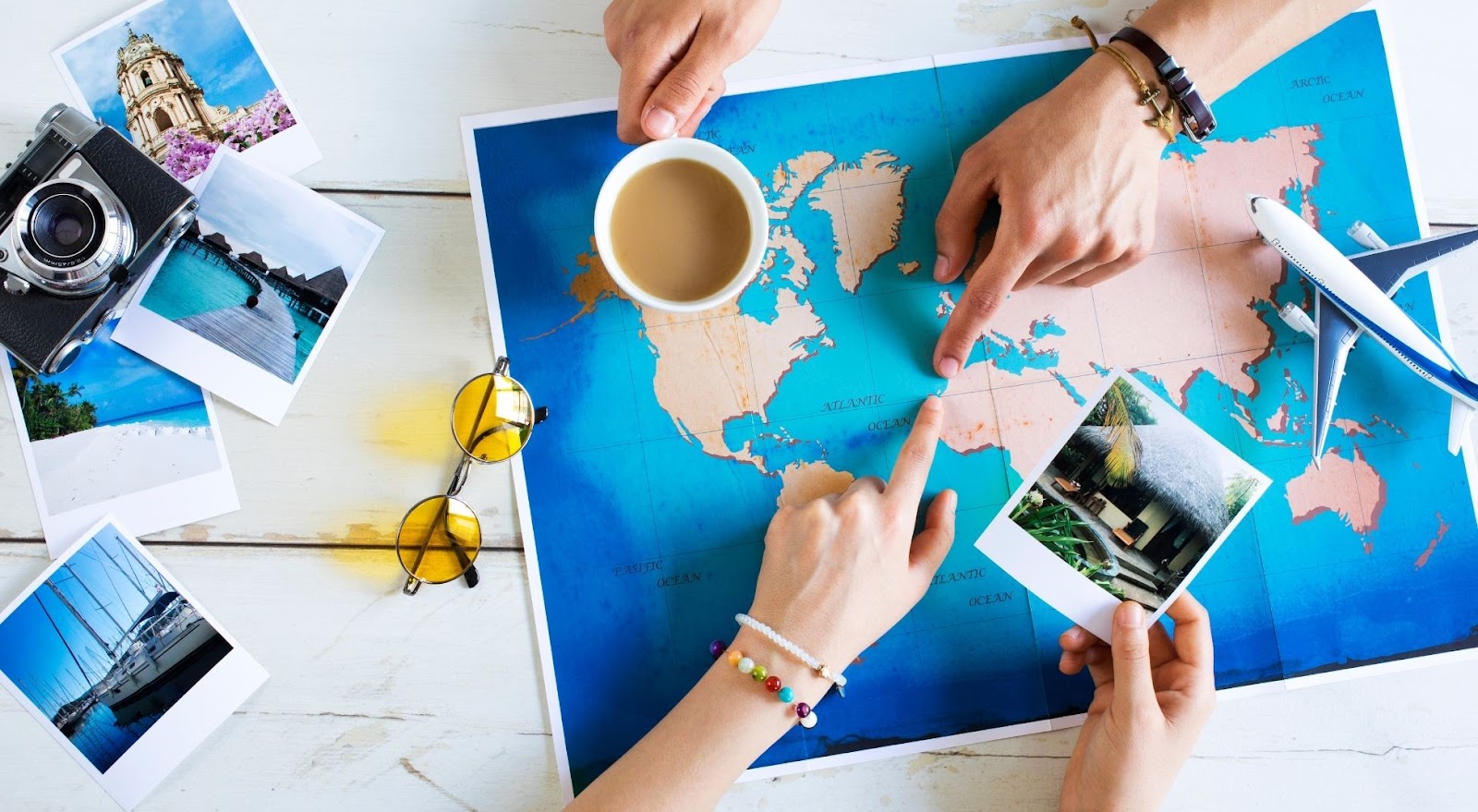 Traveler organizing a vacation itinerary with a map and travel essentials